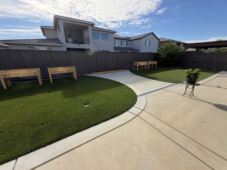 The backyard, with raised garden beds along the fence.